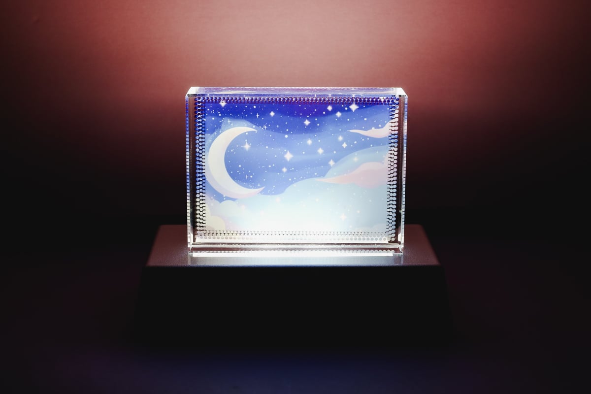 Glass sublimation nightlight with white light on.