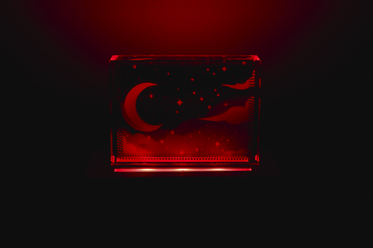 Glass sublimation nightlight with red light.