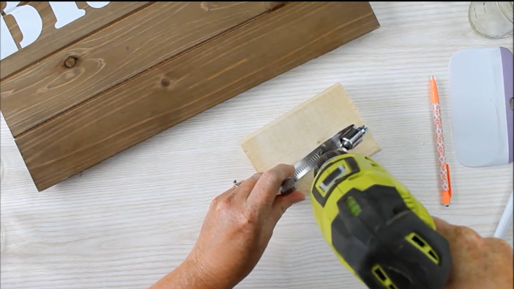 Drill through clamps to make mason jar wall decor
