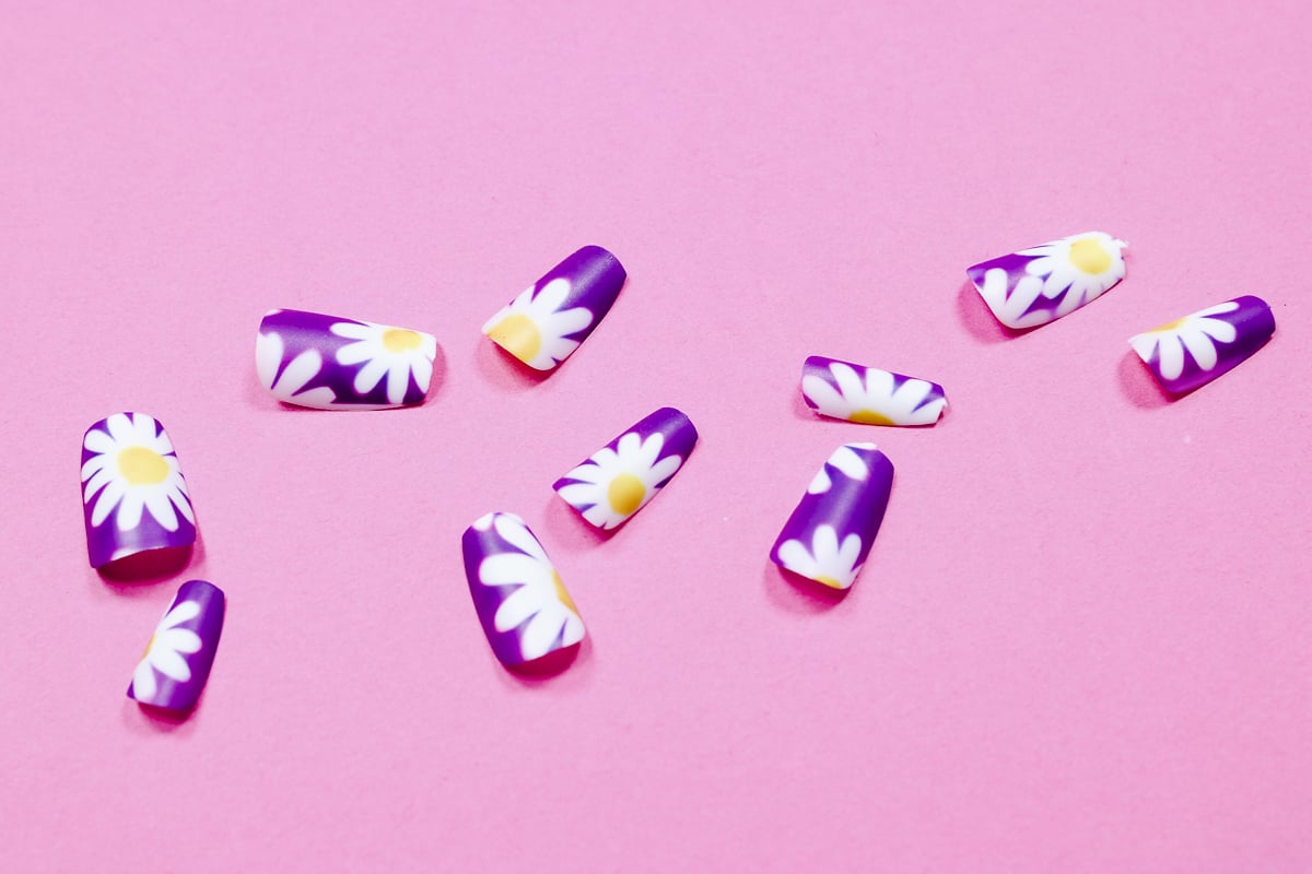 Close up of finished sublimation nails with sublimation vacuum tray.
