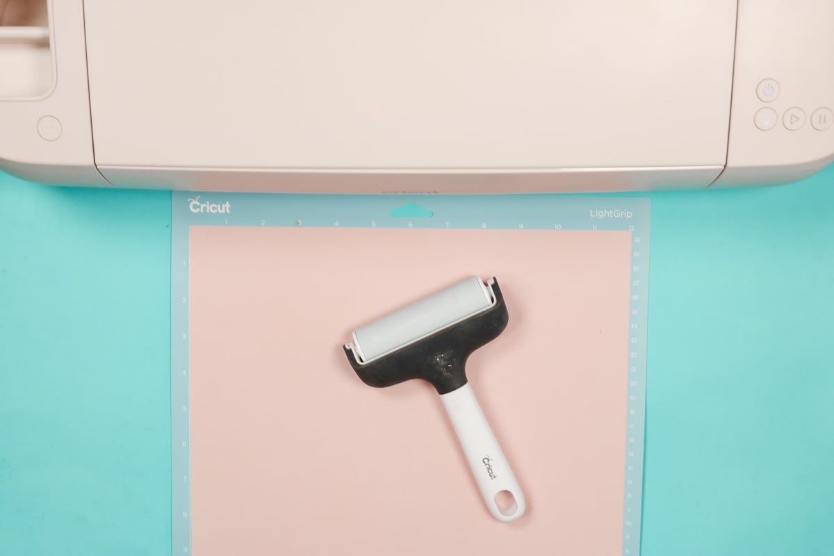 Use a brayer to attach the cardstock to the cutting mat.