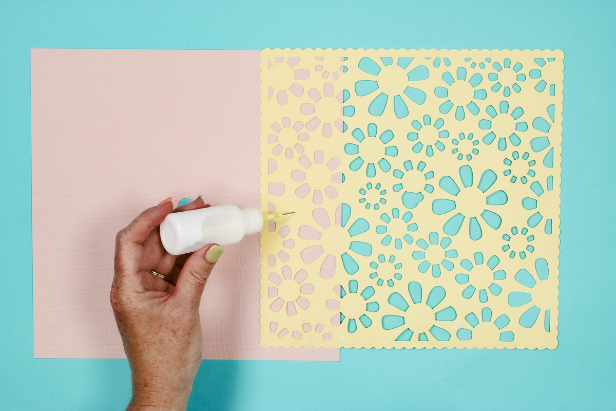 Add glue to the back of the floral piece.