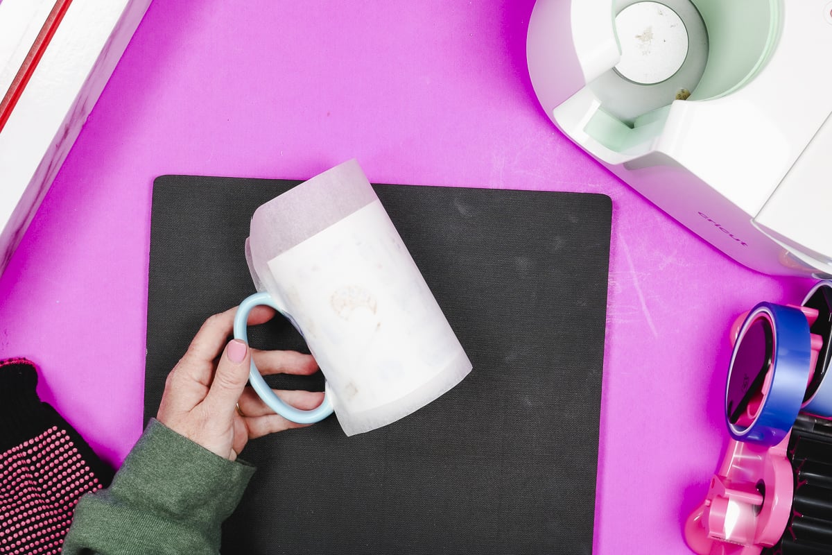 Wrap protective paper around sublimation print on mug.