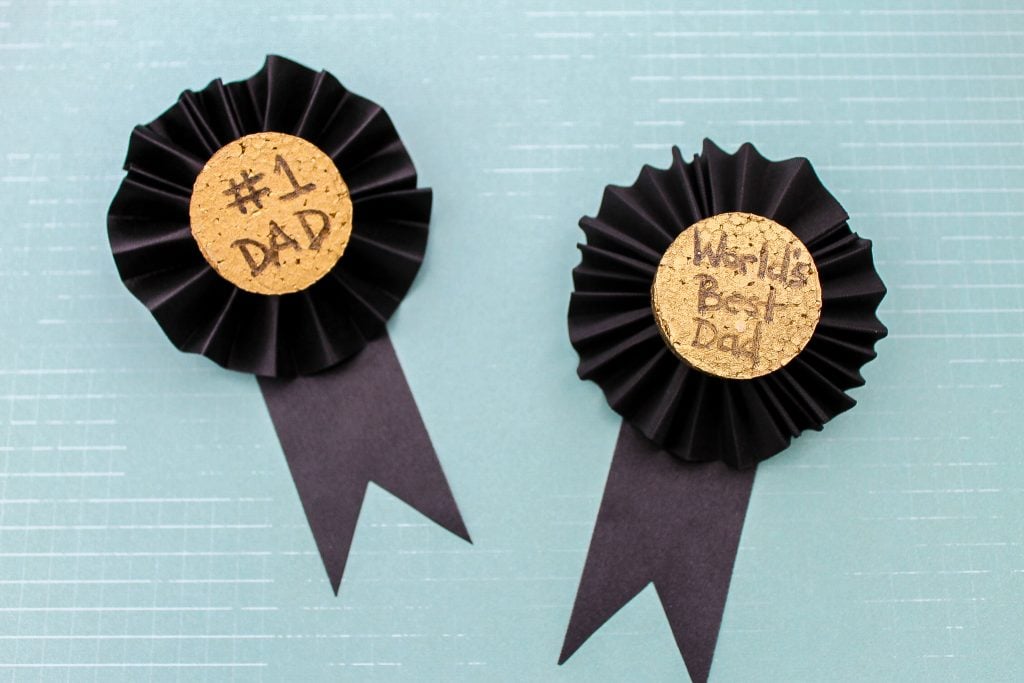 These Father's Day medals are a great craft for kids to help make for Dad. Turn the kids loose on the painting and text while you fold the ribbon and add a pin. Dad will be proud to wear these medals on his big day!These Father's Day medals are a great craft for kids to help make for Dad. Turn the kids loose on the painting and text while you fold the ribbon and add a pin. Dad will be proud to wear these medals on his big day! Kids Craft medals for Dad