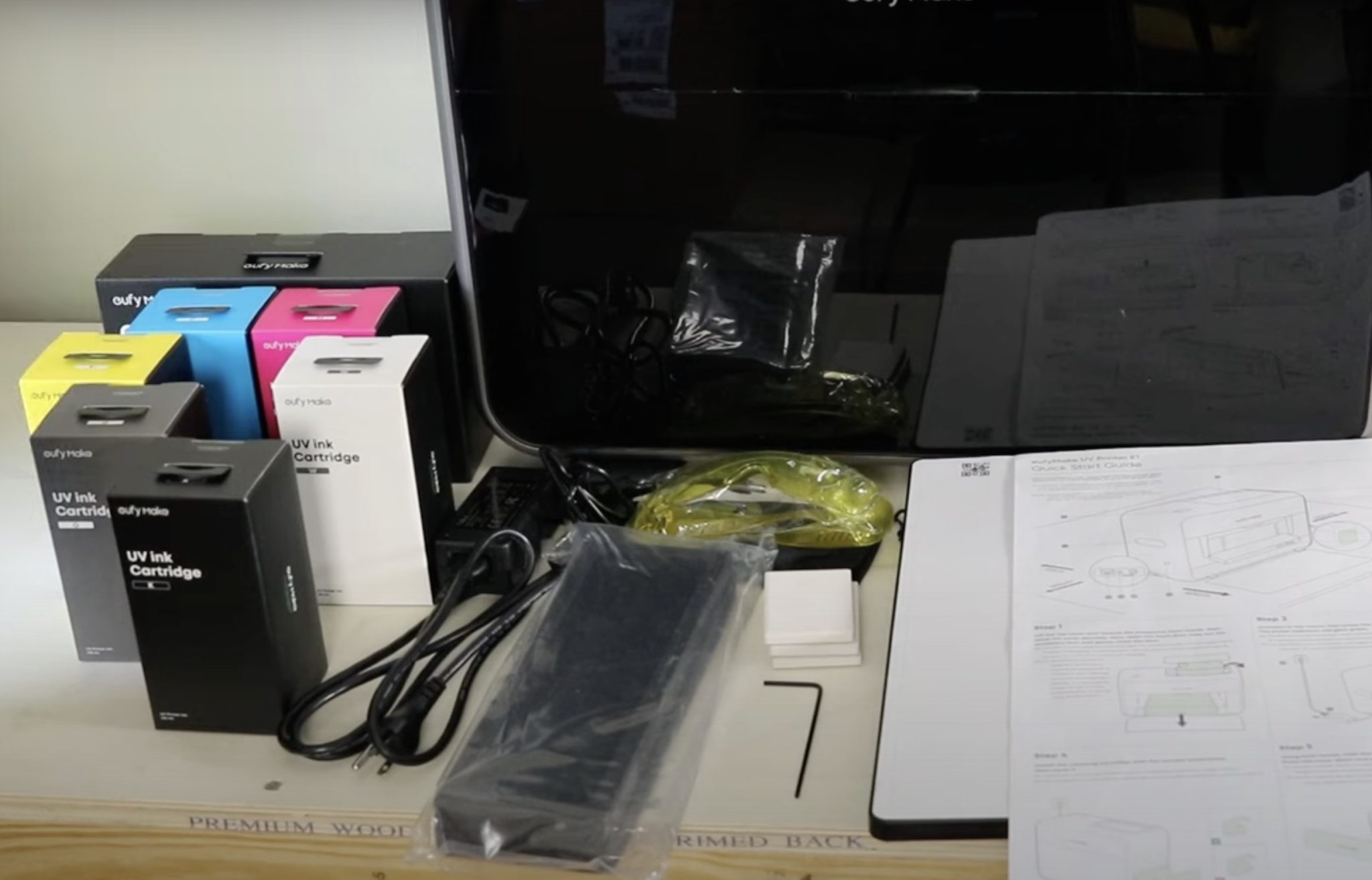 E1 printer unboxed with additional supplies.