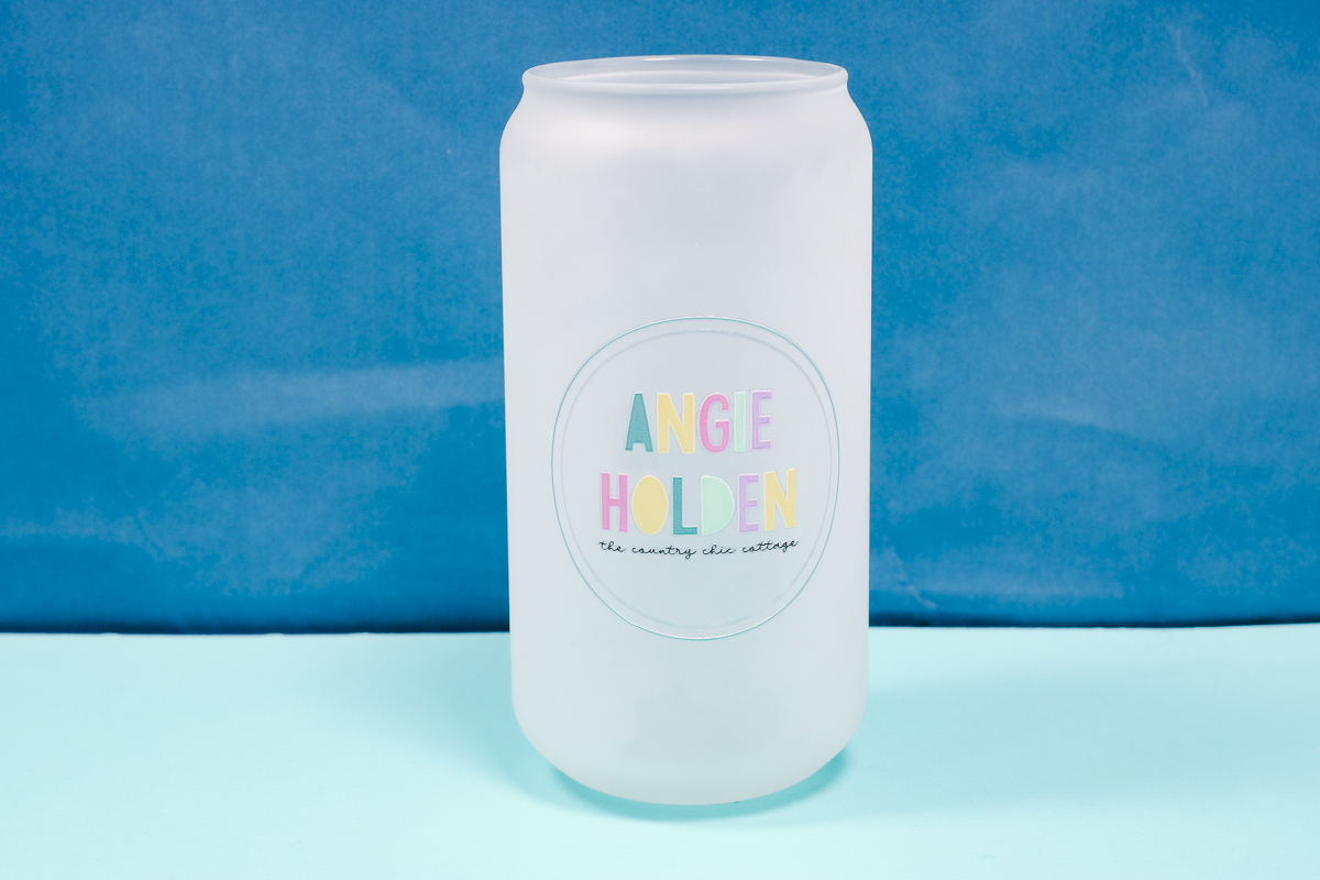 Glass can with UV DTF sticker applied.