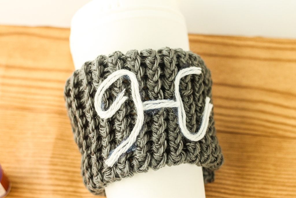 Yarn monogram on knit sleeve