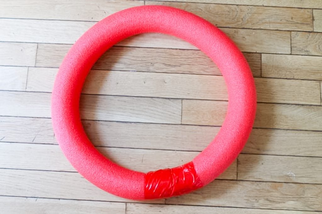 Pool noodle taped into a wreath shape