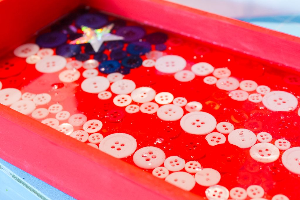 Epoxy covered buttons on painted wooden tray