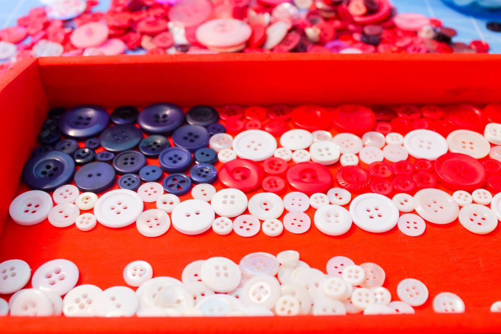 Buttons on a painted wooden tray