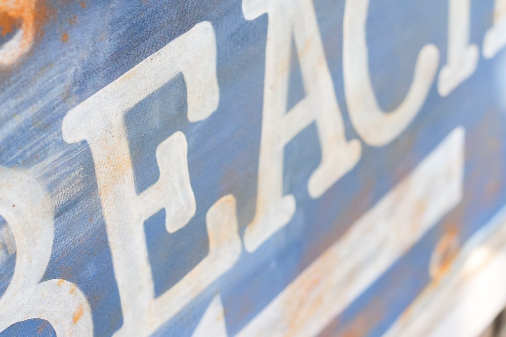 Ballard Designs Knock Off Beach Sign -- a great technique for getting a rusty appearance on a painted sign easily. You probably already have the secret ingredient in your kitchen! using paint to create a distressed sign