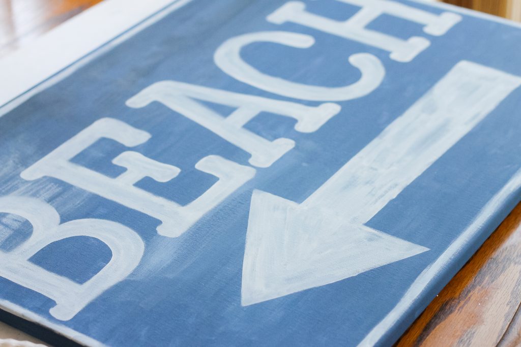 Ballard Designs Knock Off Beach Sign -- a great technique for getting a rusty appearance on a painted sign easily. You probably already have the secret ingredient in your kitchen! arrow painted on beach sign