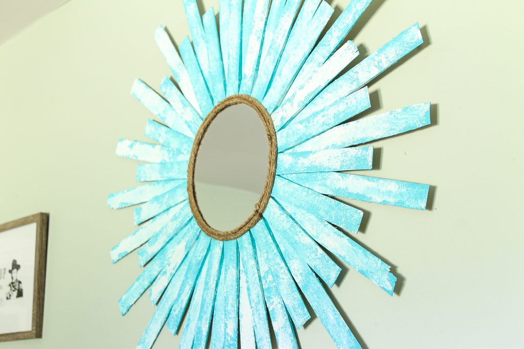 close up of straburst mirror hanging on a wall