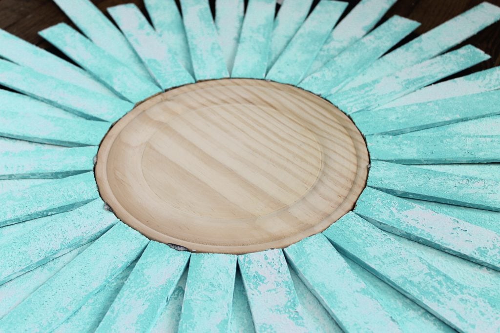 painted shims attached to wooden round