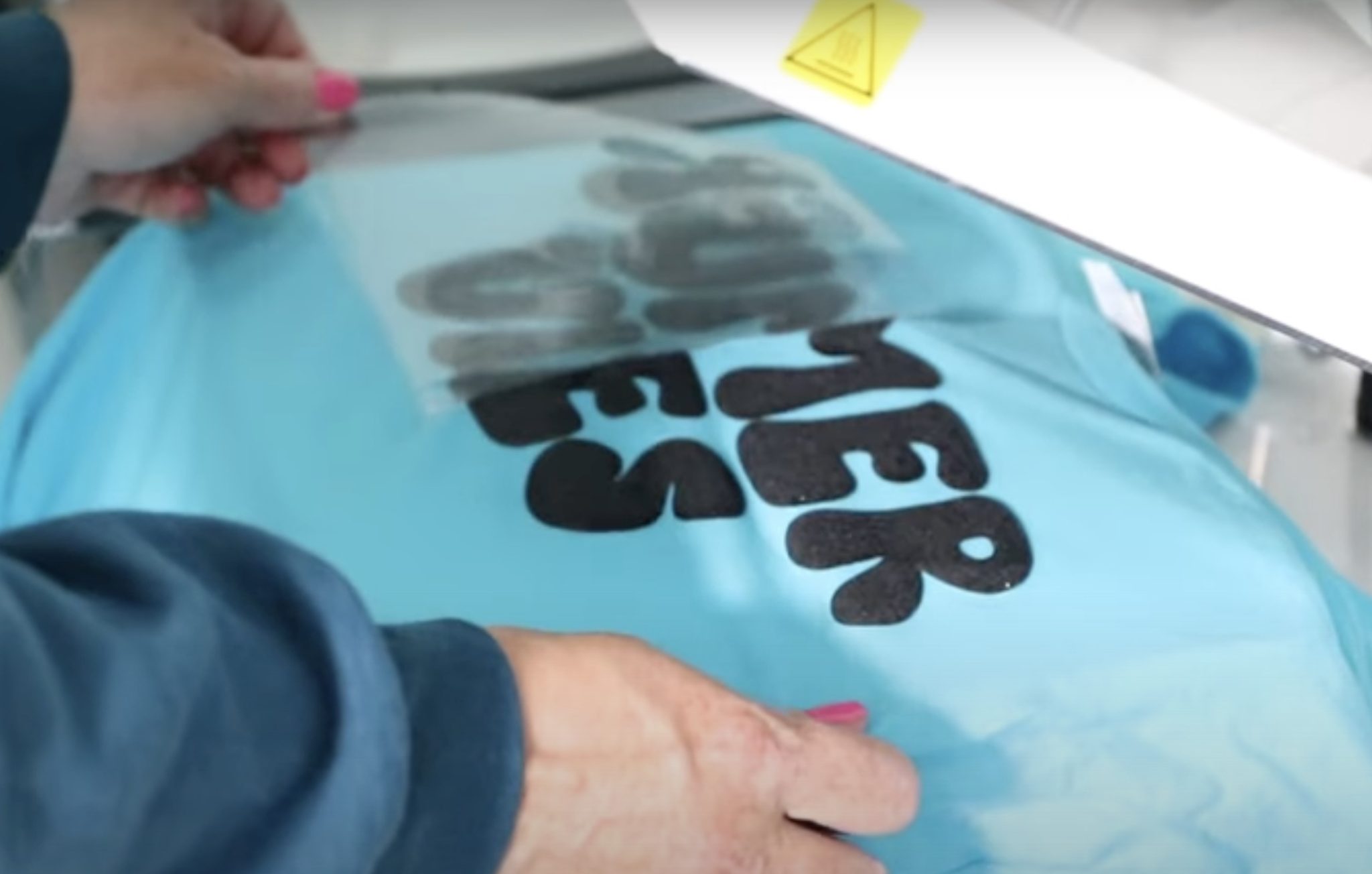 Peel back carrier sheet while HTV is hot.