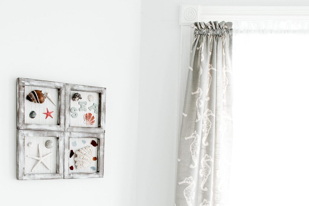 framed shells on bathroom wall