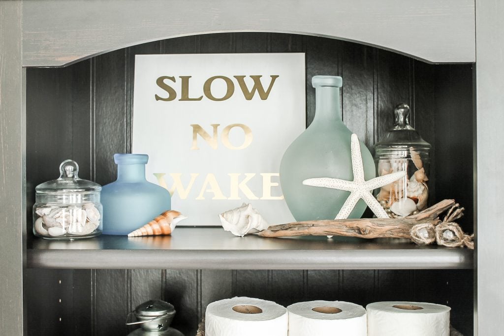 beach trinkets on bathroom shelf