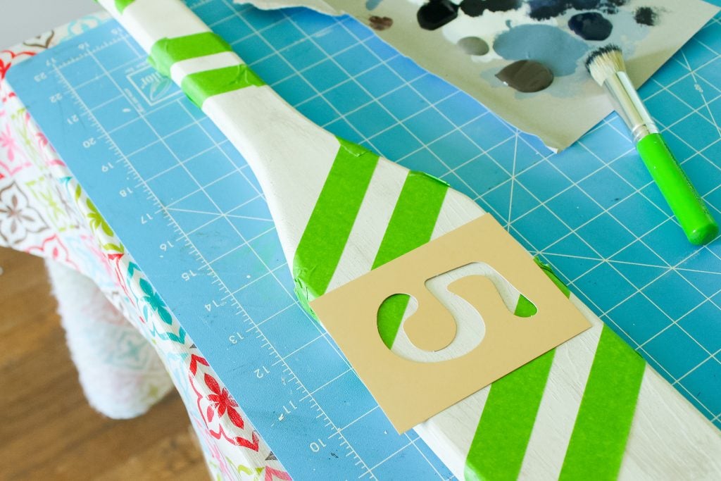taped oar and stencil ready to paint