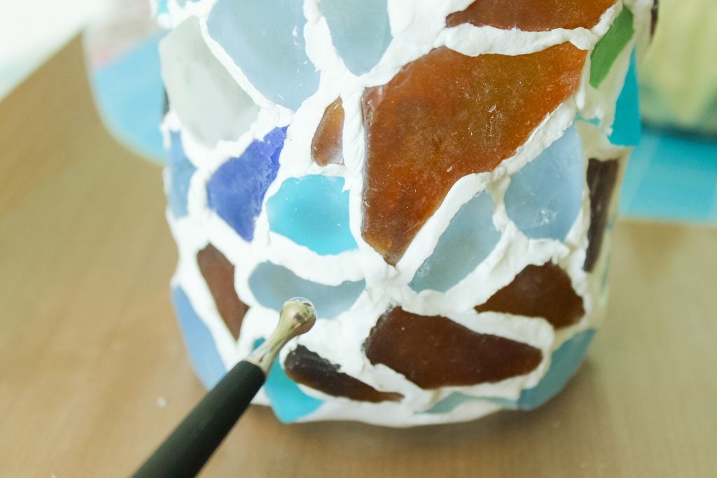 clay tool to smooth clay on jar