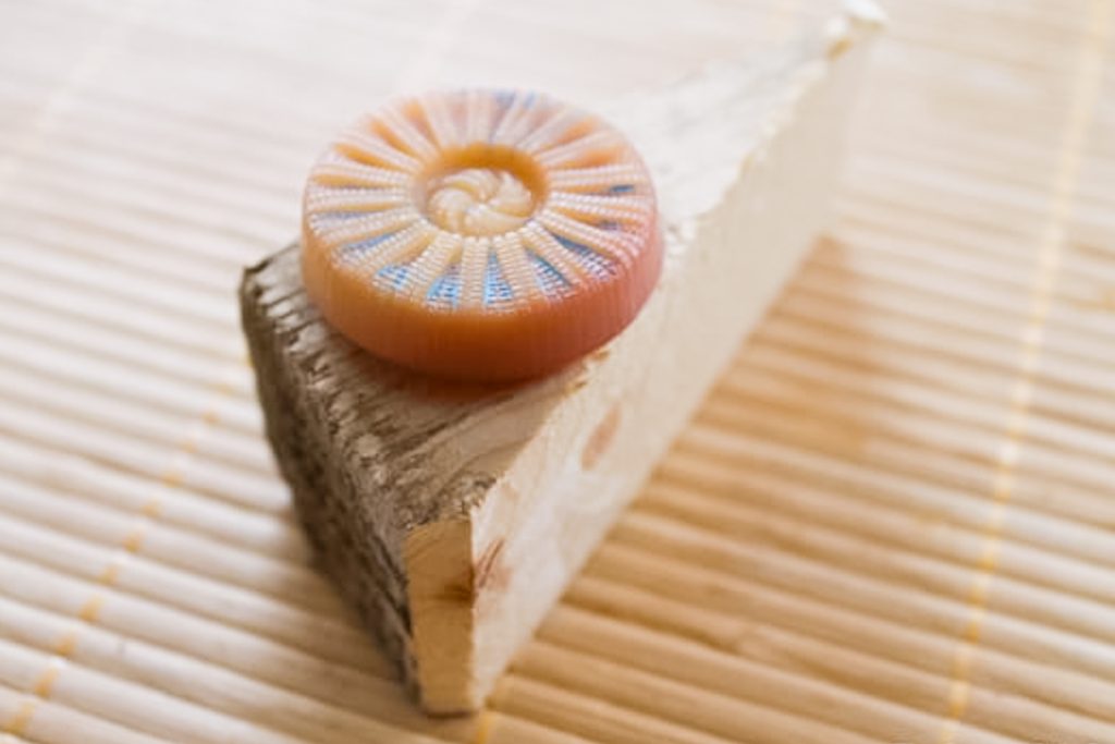 button attached to scrap wood to make a stamp