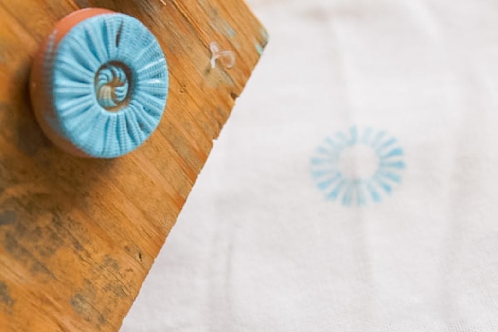 testing button stamp on a piece of fabric