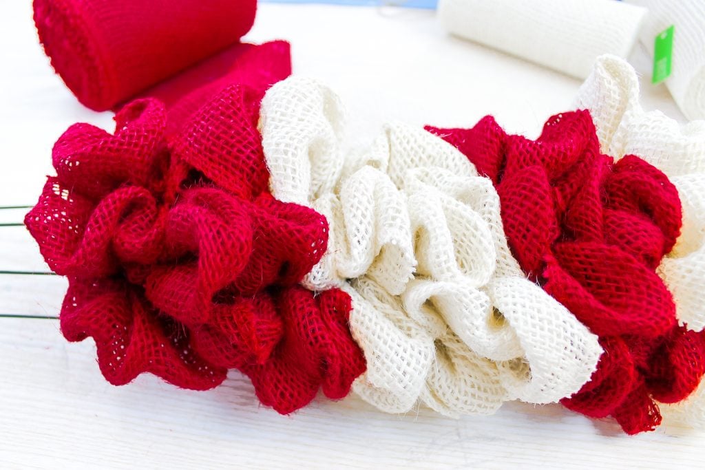 Adding burlap ribbon to wire frame