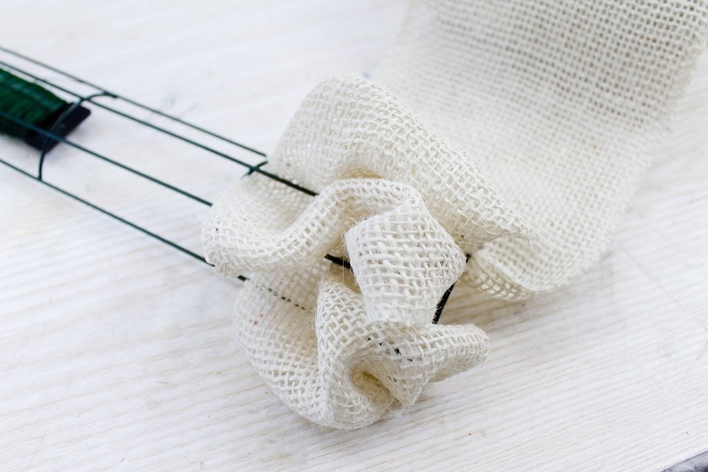 adding burlap ribbon to wreath frame