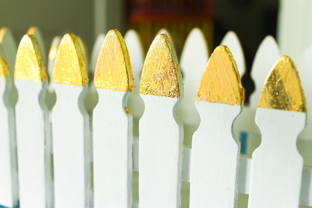 Gold leaf on the tips of a picket fence plant box