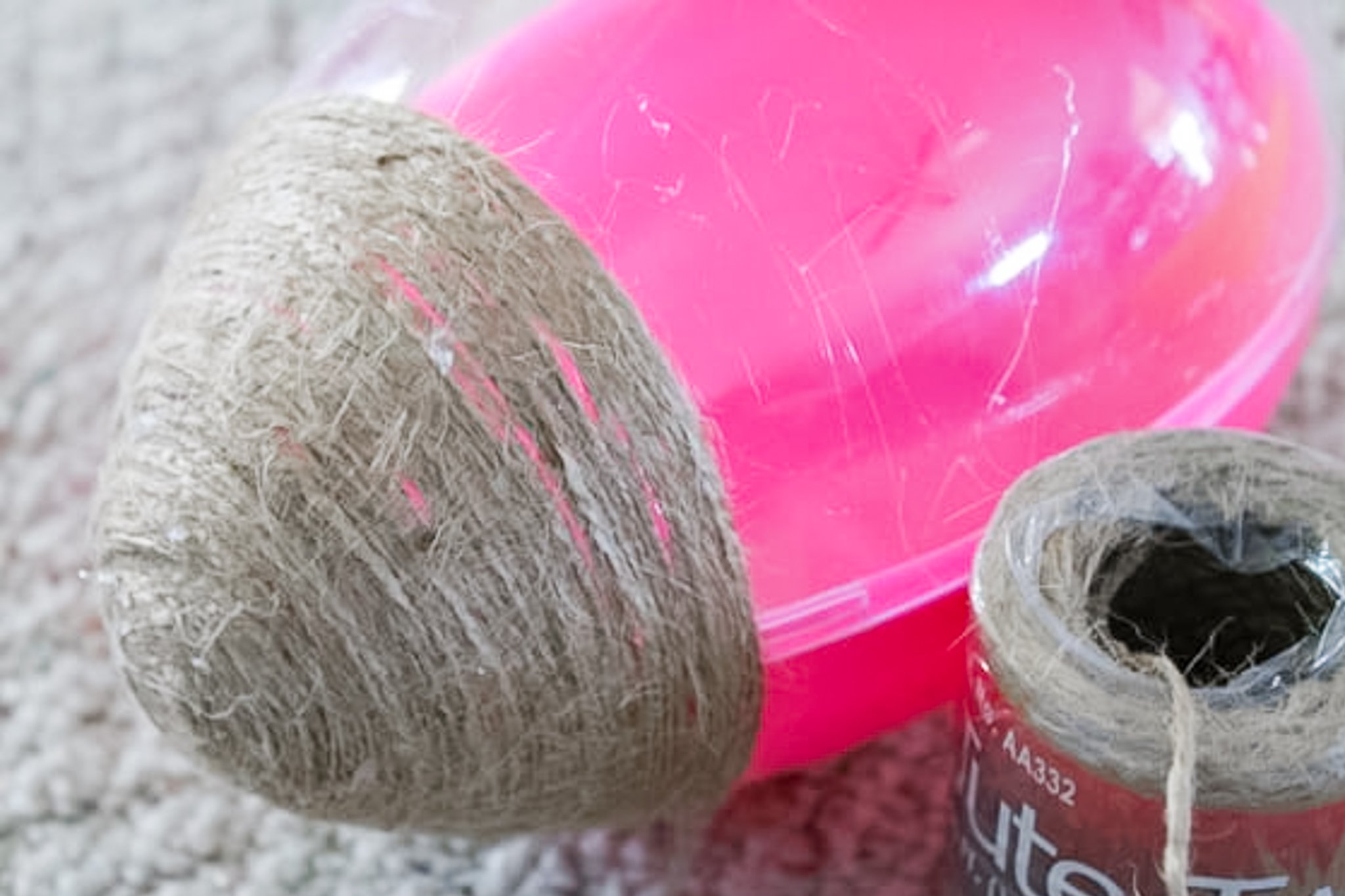 Using hot glue and jute on a large plastic egg