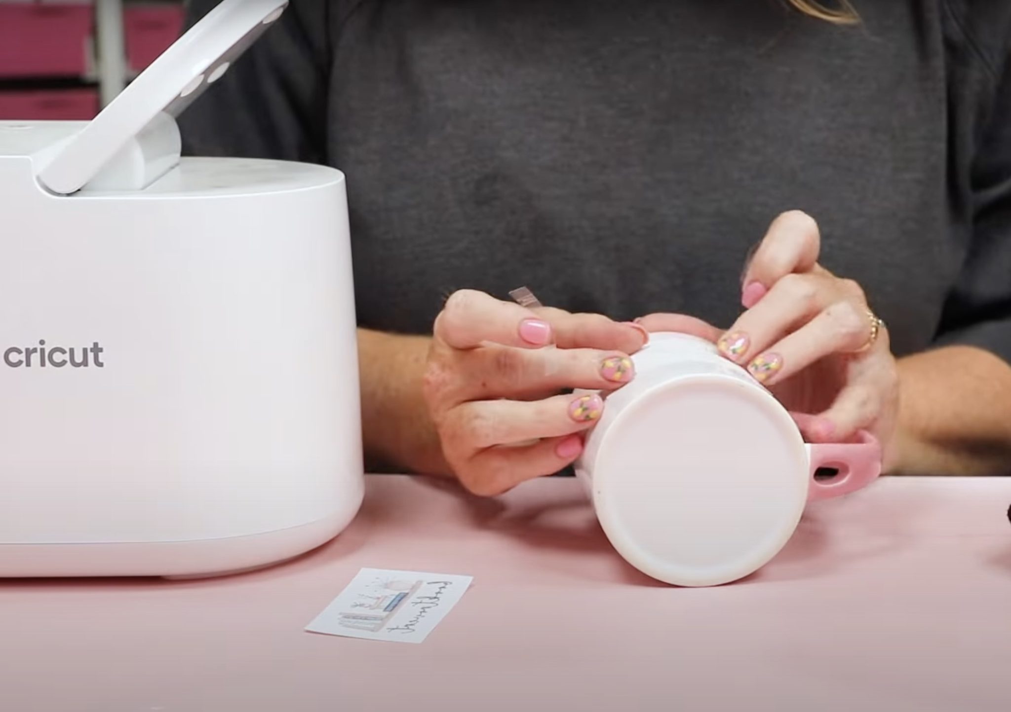 Add print to mug with heat-resistant tape.