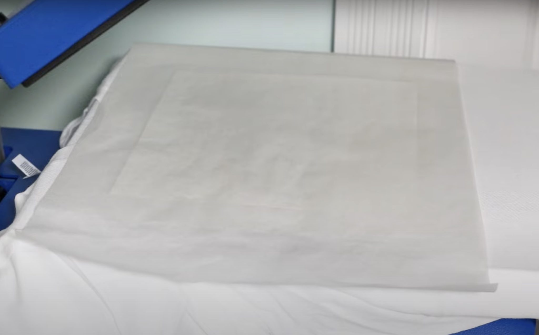 Cover print with protective paper before pressing.