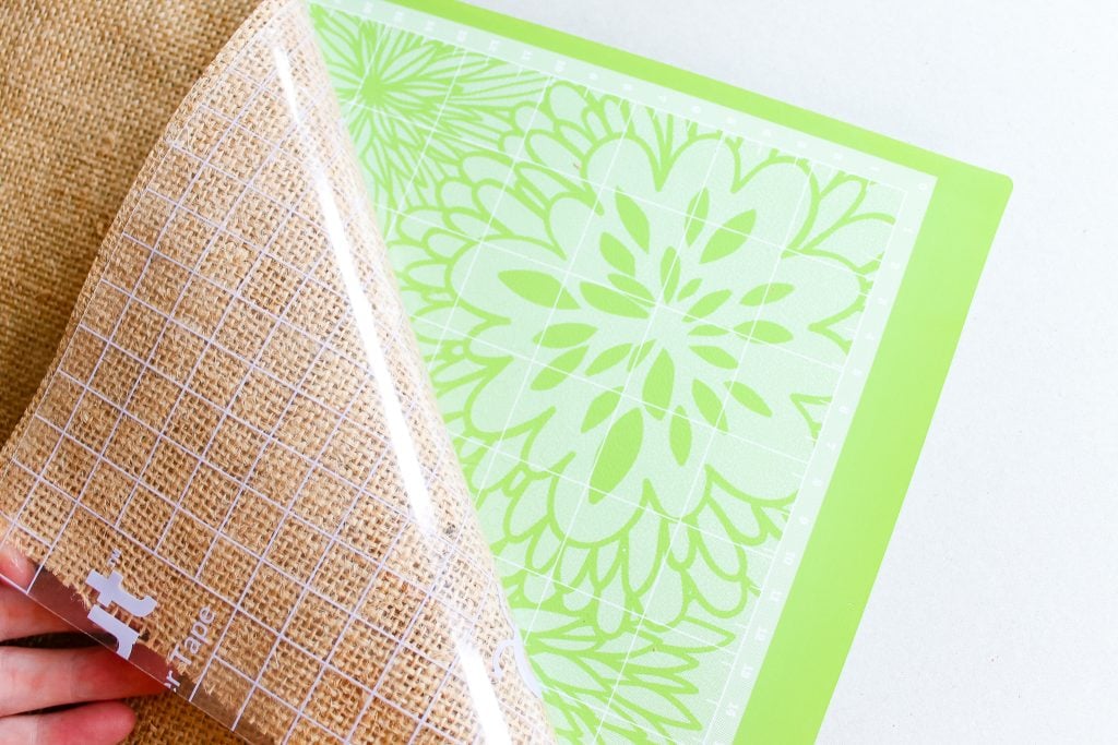 adding burlap and strong transfer tape to a cutting mat