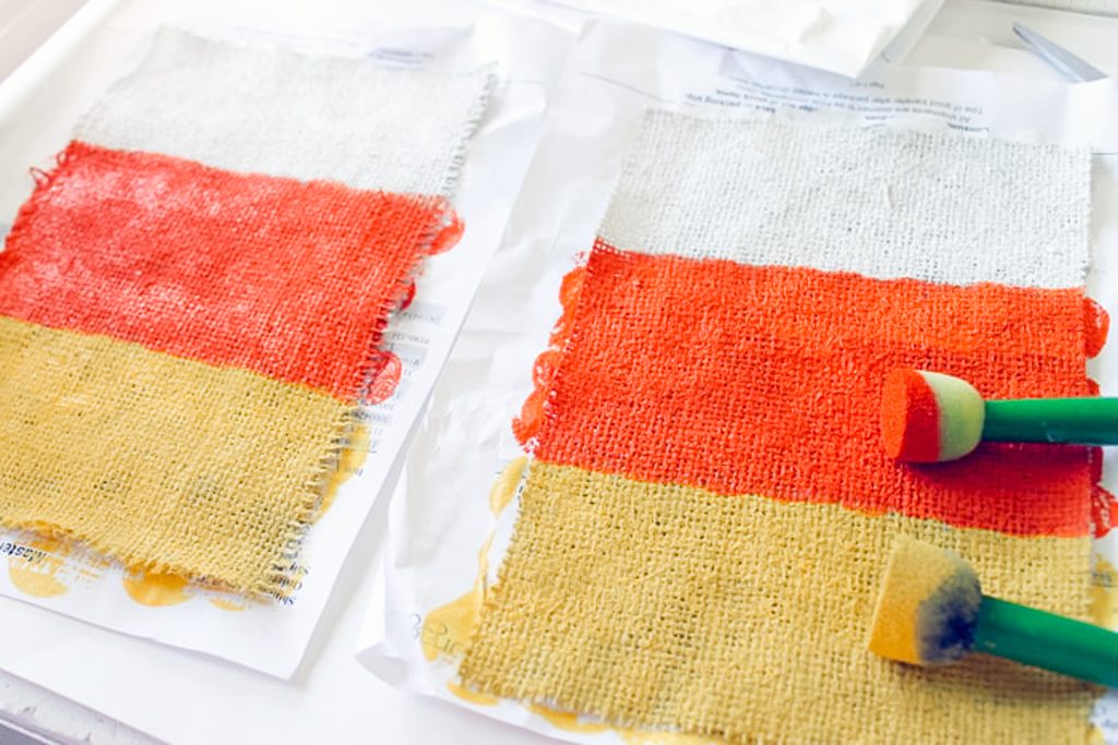 dabbing craft paint on burlap pieces
