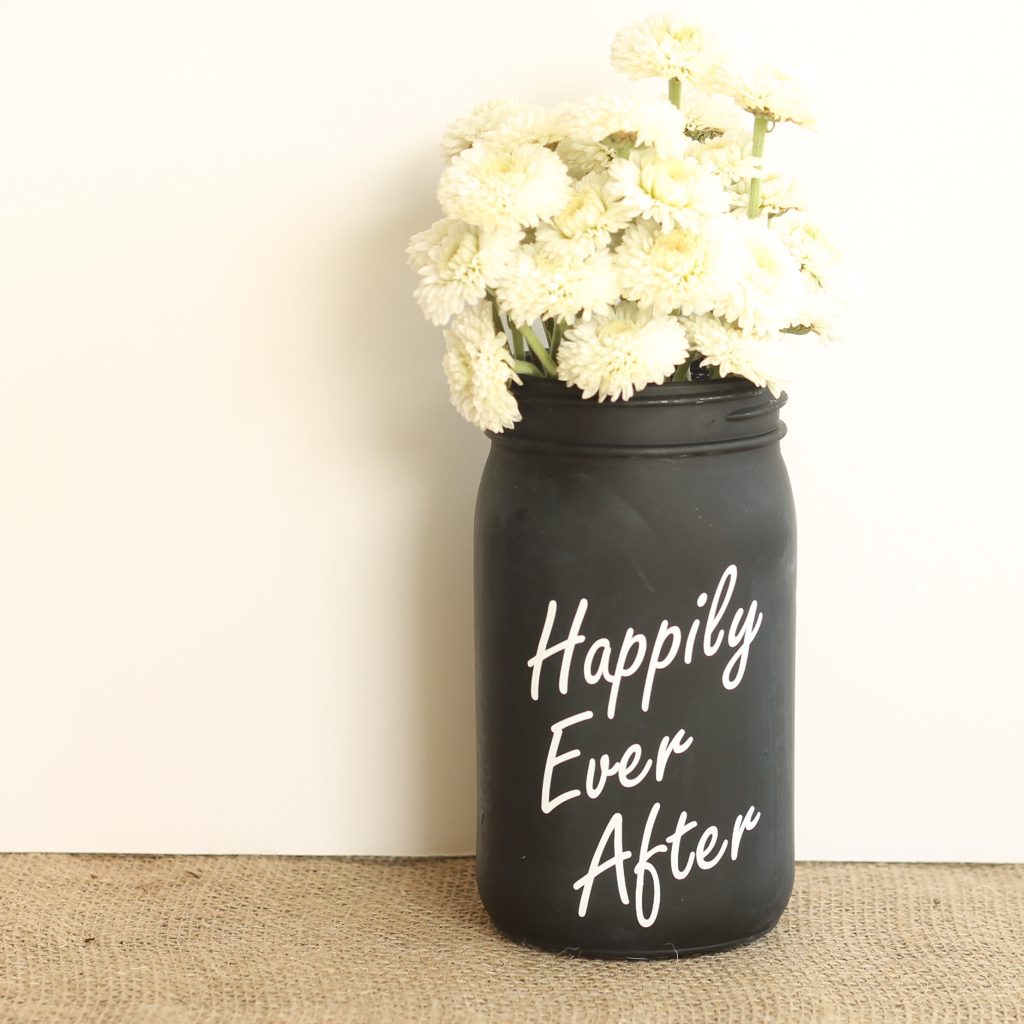 white mums in a painted mason jar