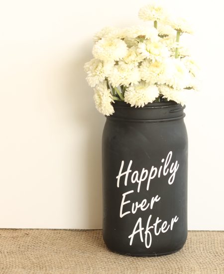 white mums in a painted mason jar