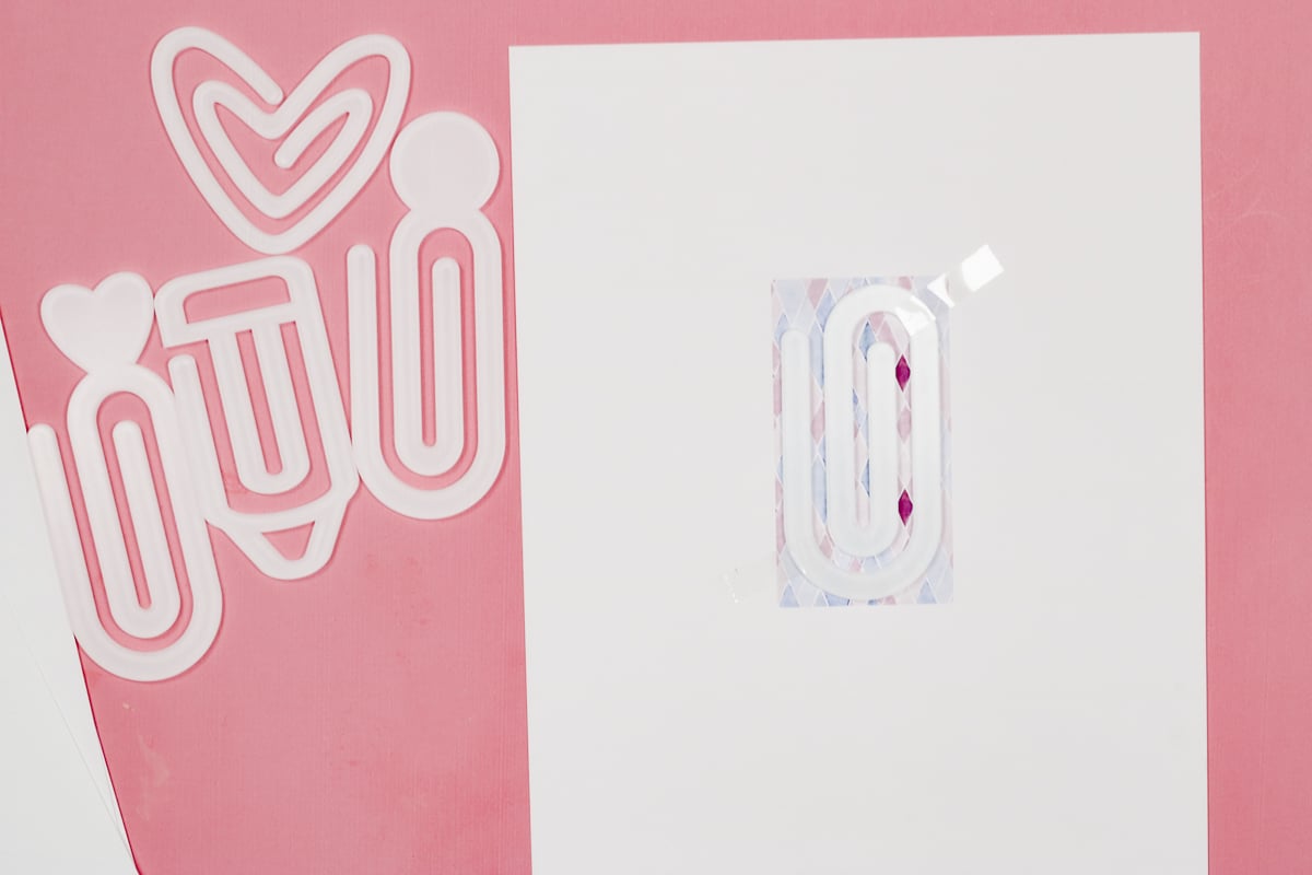 Locate paper clip on design.
