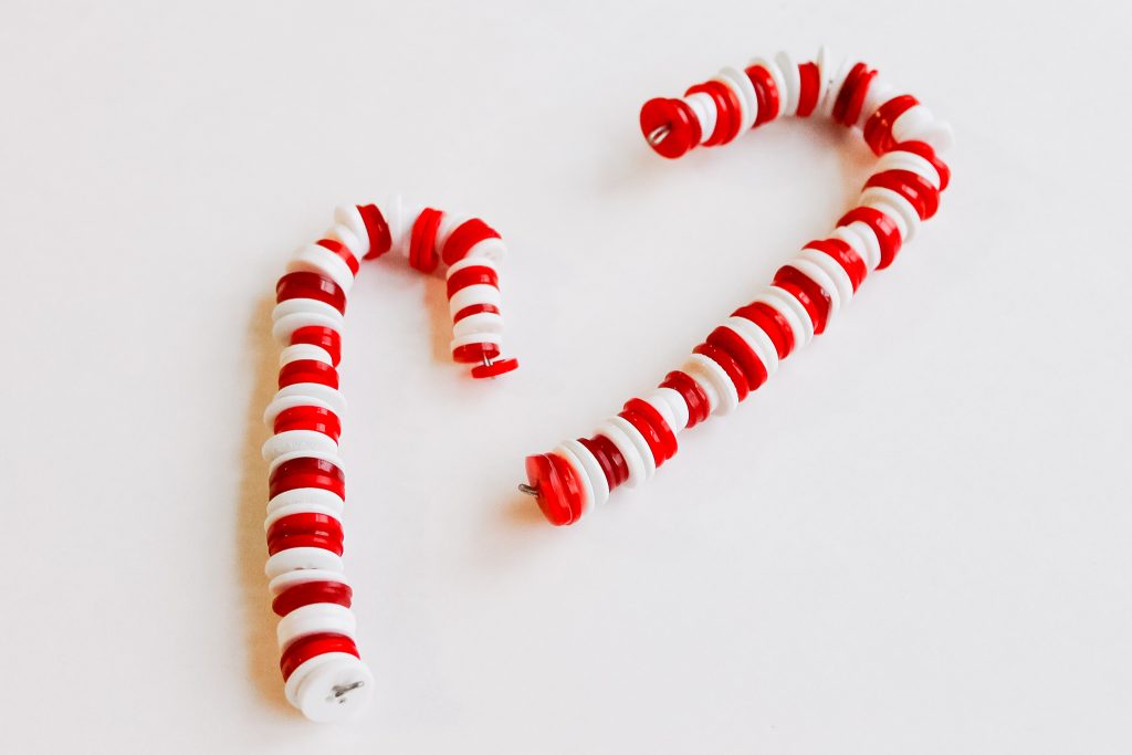 Button Candy Cane Christmas Ornaments -- handmade ornament tutorial that will have your tree full of button candy canes in no time. Candy canes made from wire and buttons