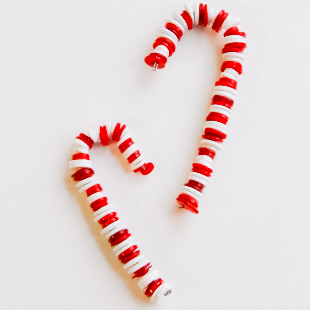 Button Candy Cane Christmas Ornaments -- handmade ornament tutorial that will have your tree full of button candy canes in no time. Adorable candy candy ornaments