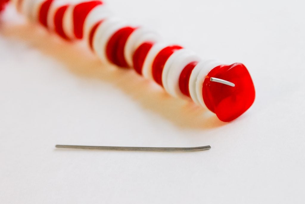Button Candy Cane Christmas Ornaments -- handmade ornament tutorial that will have your tree full of button candy canes in no time. extra wire from ornament