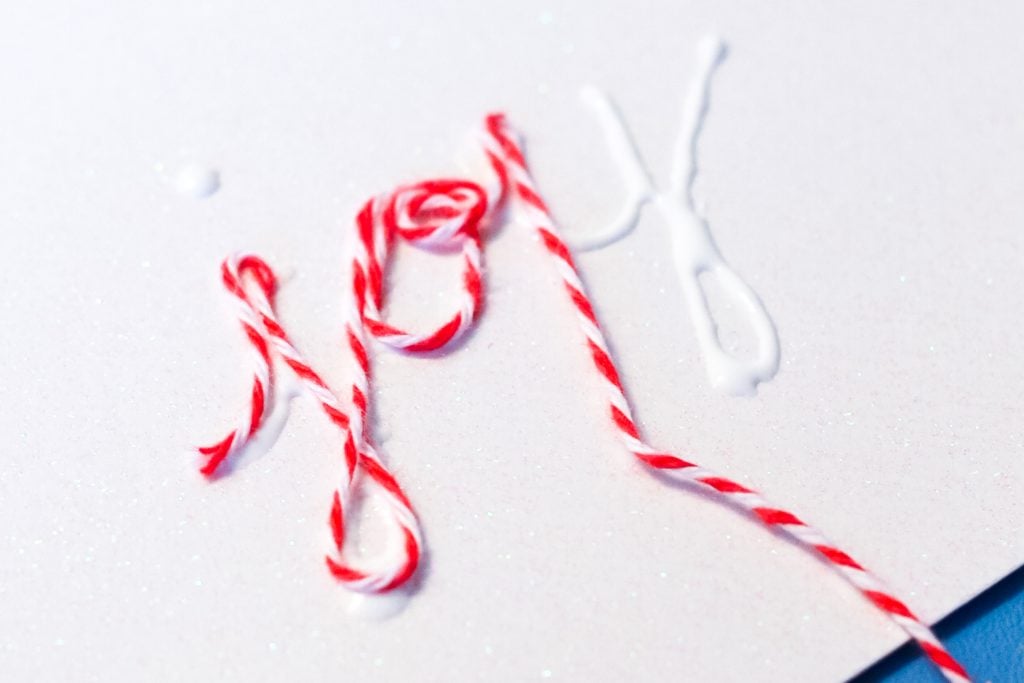 adding baker's twine to glue letters