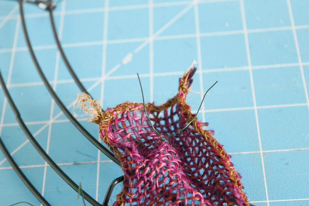 attaching burlap ribbon to a wire wreath frame