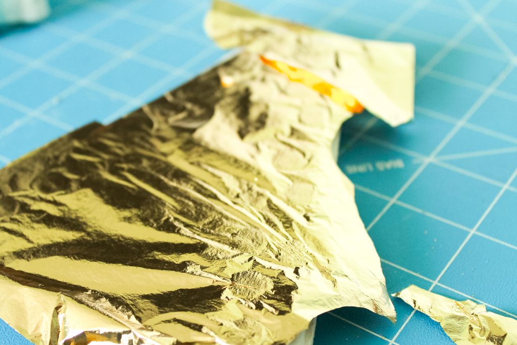 Gold leaf on a painted surface