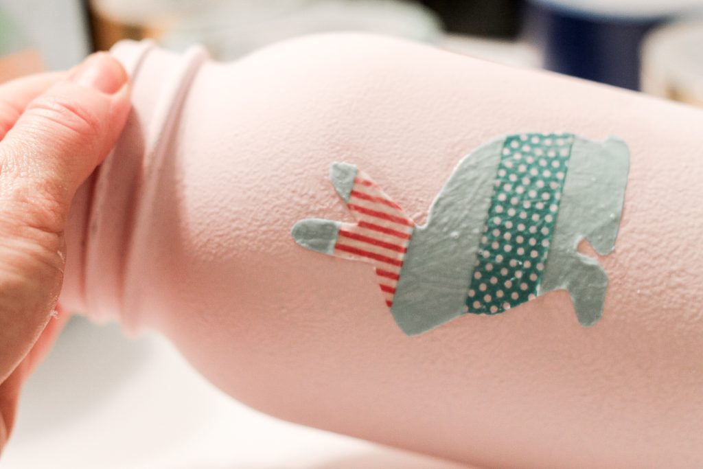 adding washi tape to a painted mason jar