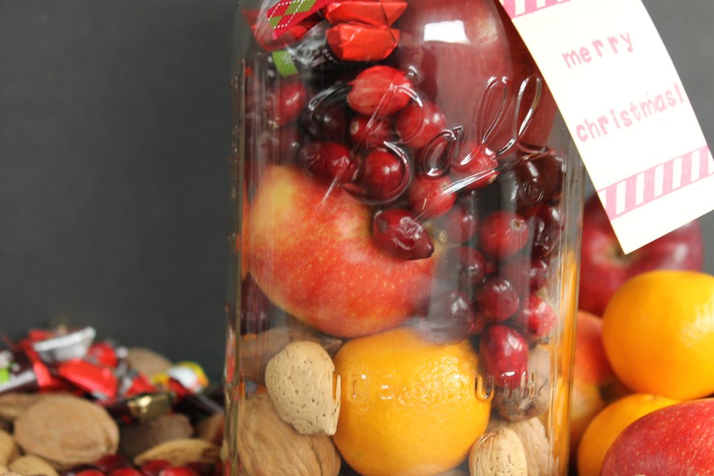 layers of fruit in a large mason jar