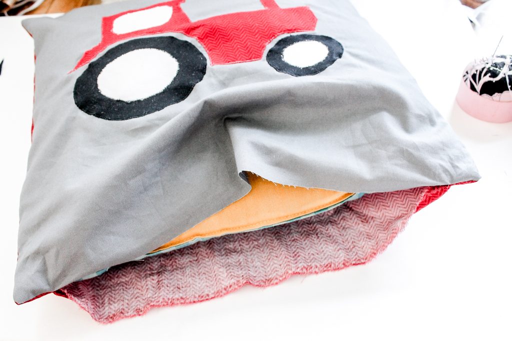 Inserting pillow form into sewn pillow case