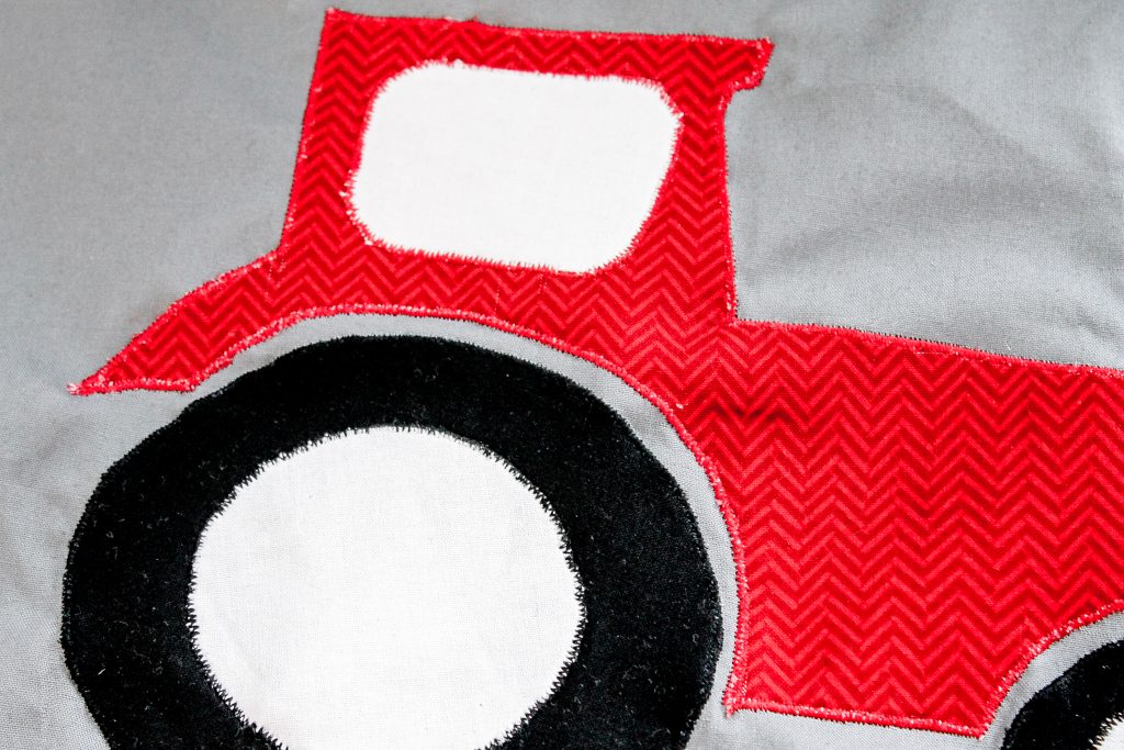 red, white and black fabric sewn onto a great piece of fabric