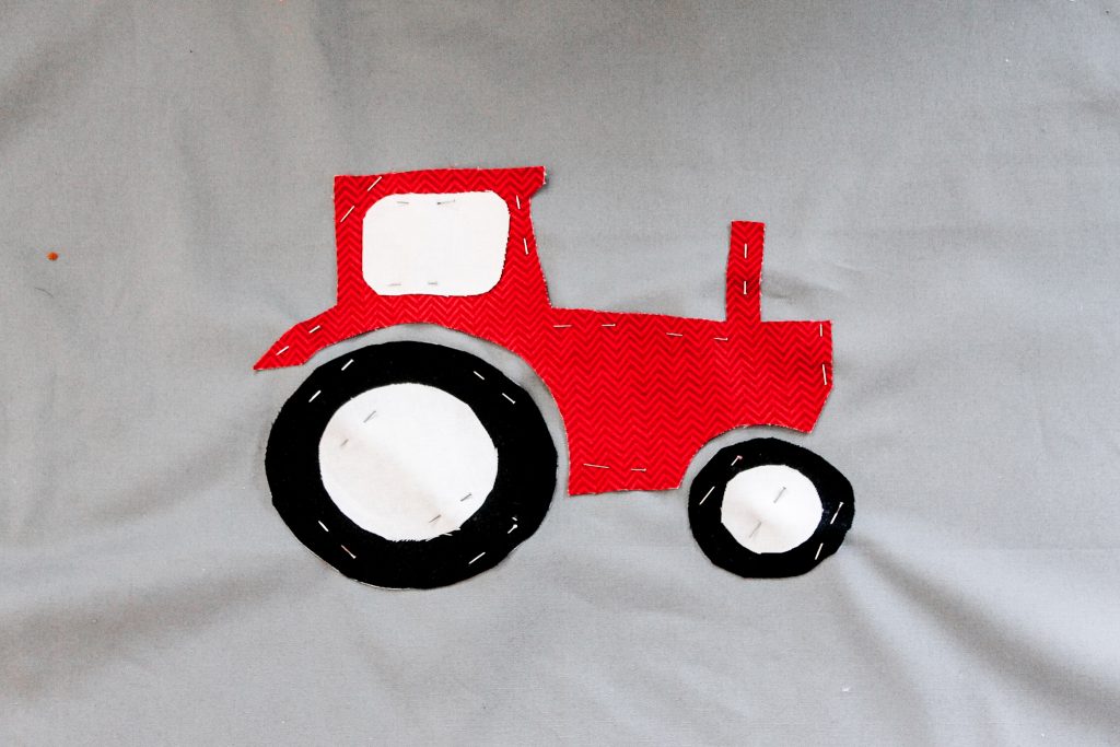 fabric piece pinned onto grey fabric