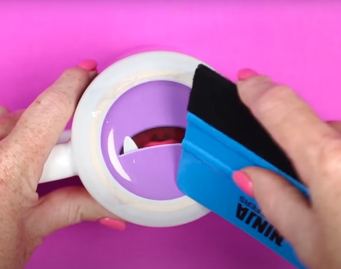 Use scraper to apply sticker.