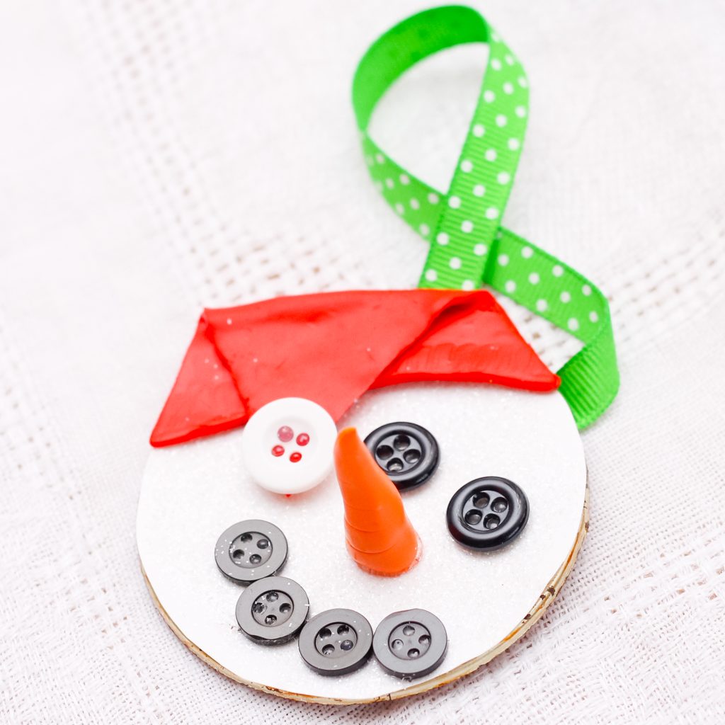 Adorable snowman ornament made with a canning jar lid