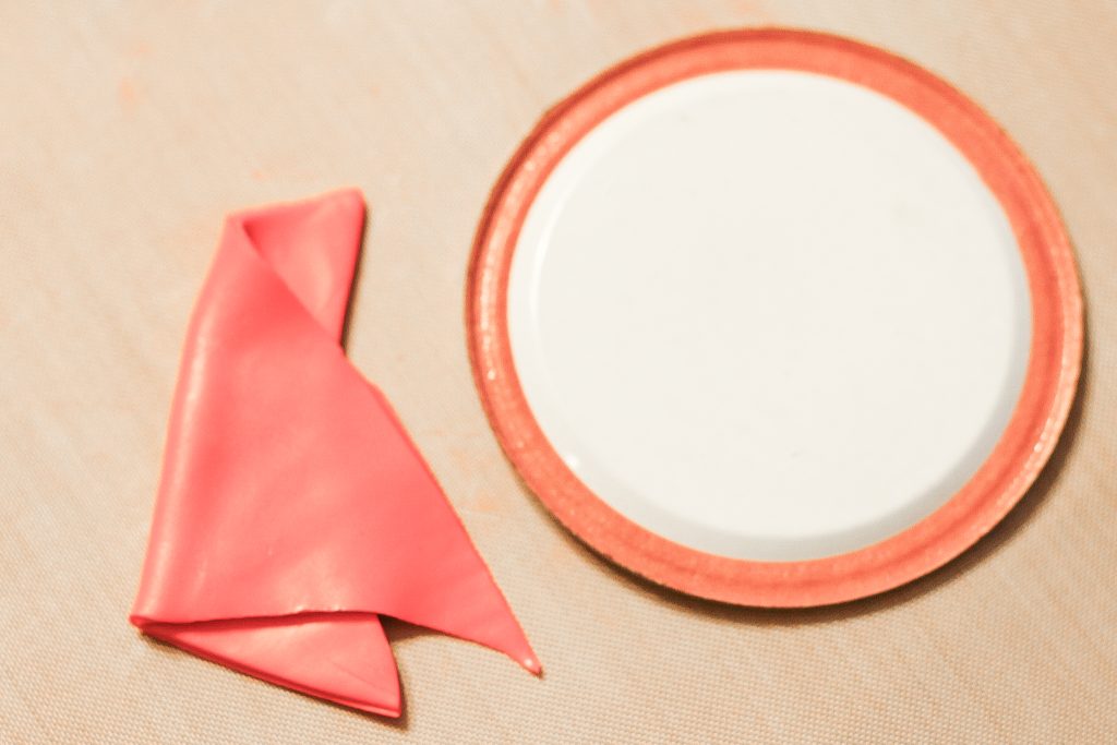 Folding a piece of sculpy to make a hat
